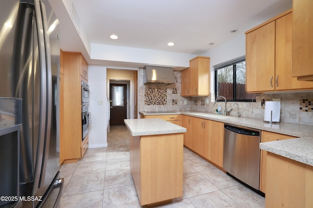 kitchen featuring sink, light brown cabinets, a kitchen island, stainless steel appliances, and wall chimney range hood