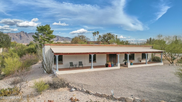 rear view of house with a mountain view and a patio area