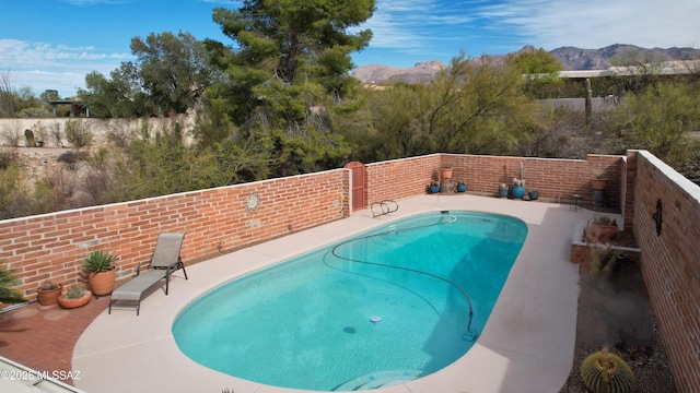 view of swimming pool with a mountain view