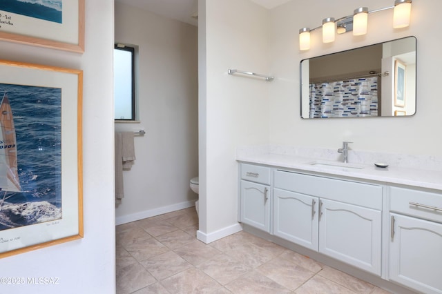 bathroom with a shower with curtain, vanity, tile patterned floors, and toilet