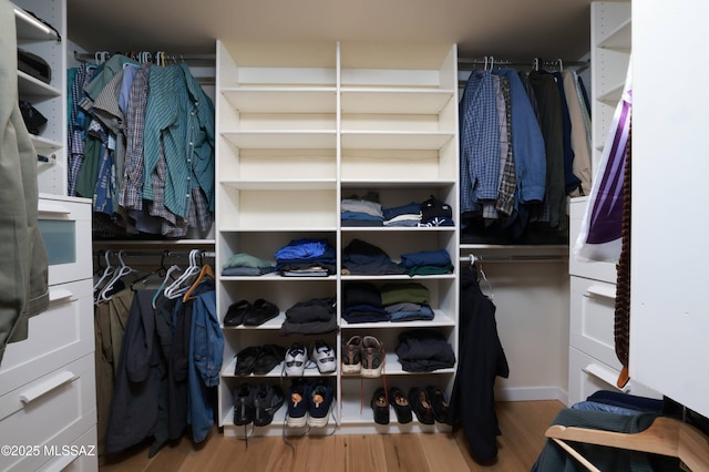 walk in closet with light wood-type flooring