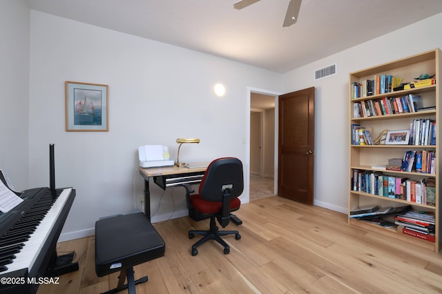 home office featuring ceiling fan and light hardwood / wood-style flooring