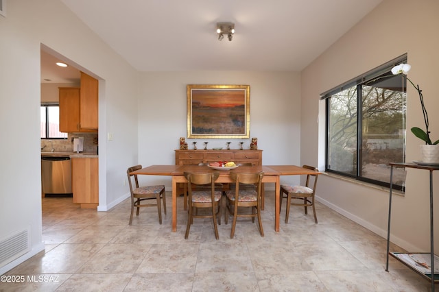 dining area featuring light tile patterned floors