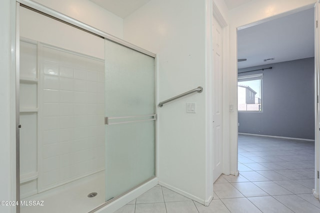 bathroom with tile patterned flooring and walk in shower