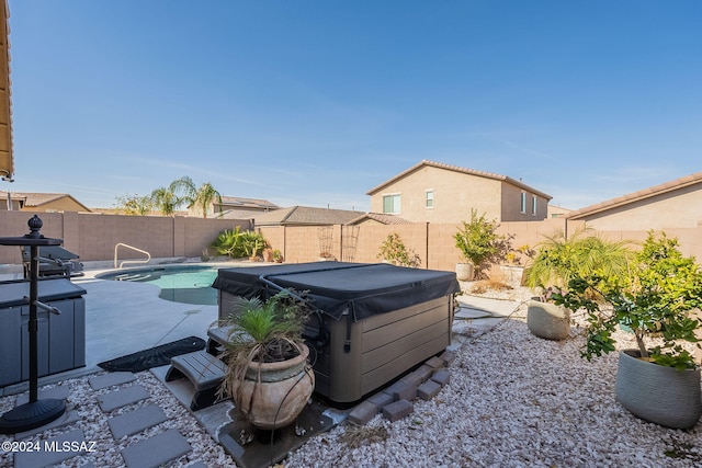 exterior space with a hot tub and a patio area