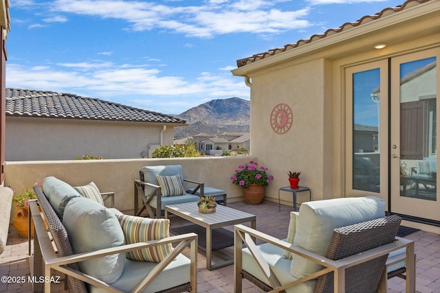 view of patio / terrace with a mountain view and an outdoor living space