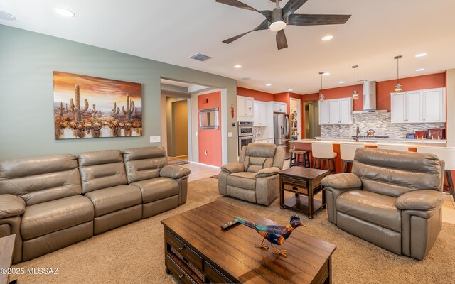 living room with light colored carpet, recessed lighting, a ceiling fan, and visible vents