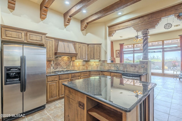 kitchen with tasteful backsplash, custom exhaust hood, stainless steel appliances, and a sink