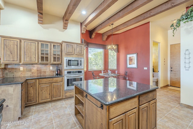 kitchen with stainless steel appliances, a kitchen island, glass insert cabinets, and brown cabinets