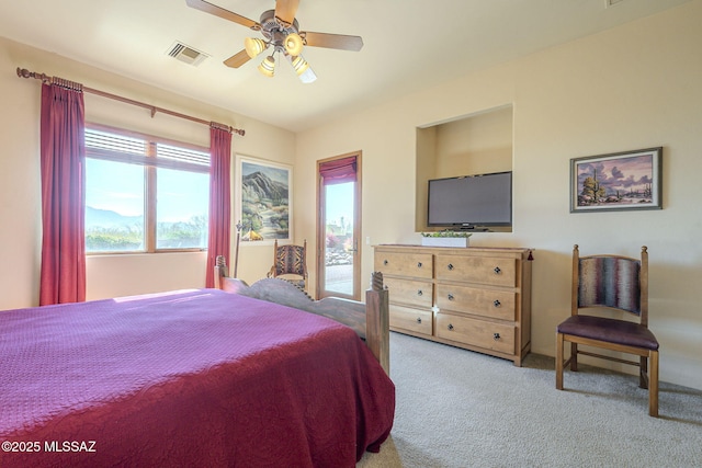 bedroom featuring access to exterior, visible vents, light carpet, and a ceiling fan