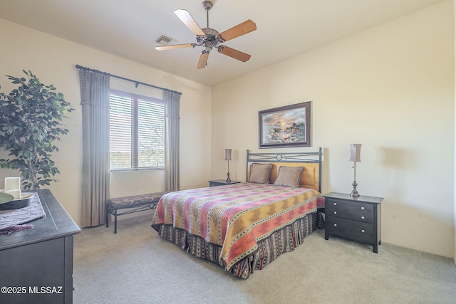 bedroom featuring light carpet, ceiling fan, and visible vents