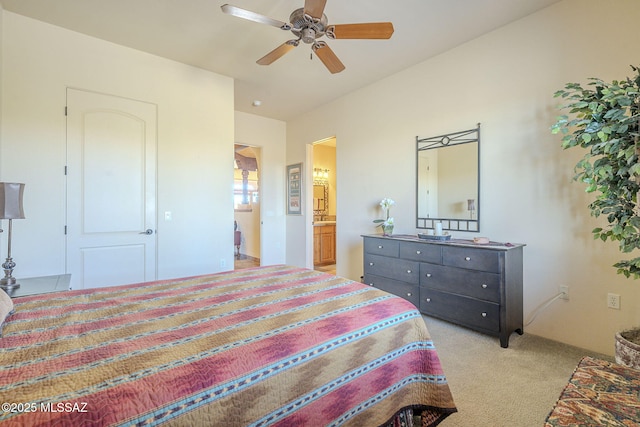 bedroom with ceiling fan, ensuite bathroom, and light colored carpet