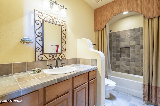 bathroom with shower / bath combo, visible vents, vanity, and toilet