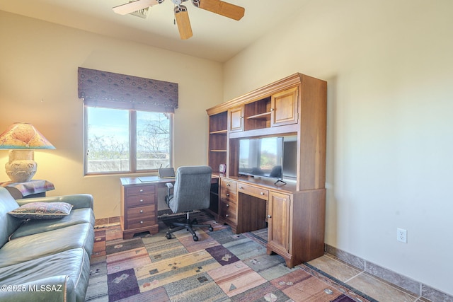 office area featuring dark tile patterned floors, baseboards, and a ceiling fan