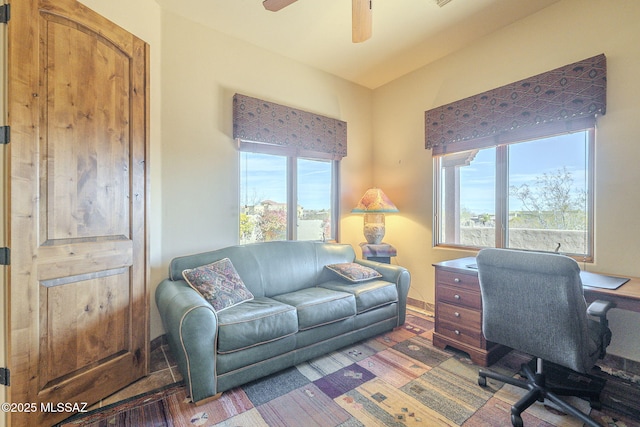 office area with a ceiling fan and wood finished floors