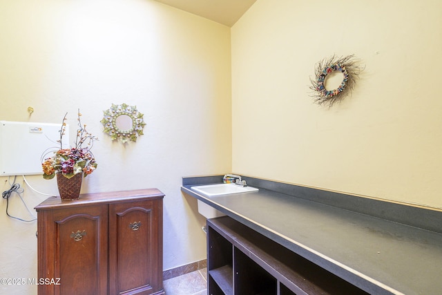 office area featuring baseboards and a sink