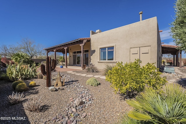 back of house featuring stucco siding and a patio