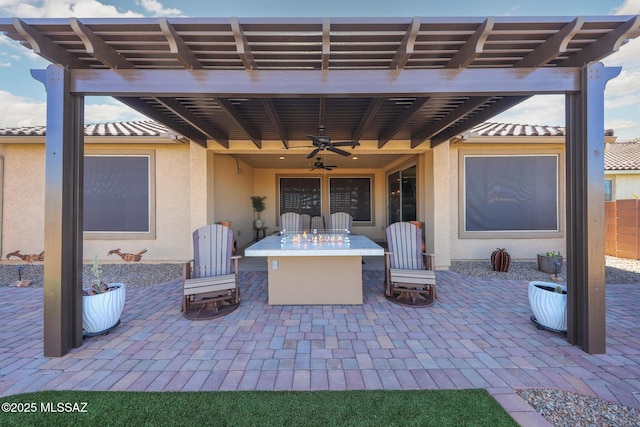 view of patio with an outdoor fire pit and ceiling fan