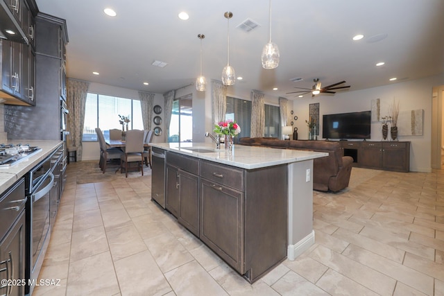 kitchen with recessed lighting, under cabinet range hood, a sink, visible vents, and appliances with stainless steel finishes