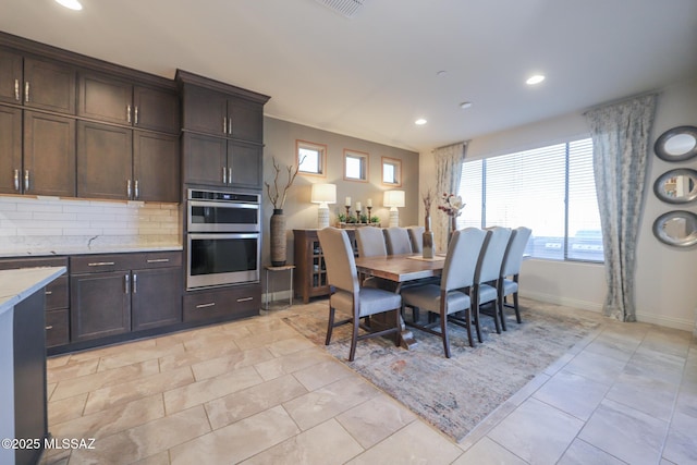 dining space with recessed lighting, baseboards, and light tile patterned floors