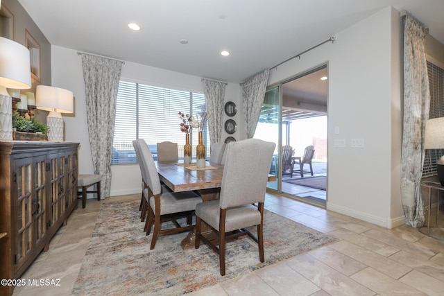 dining space featuring baseboards, a wealth of natural light, and recessed lighting