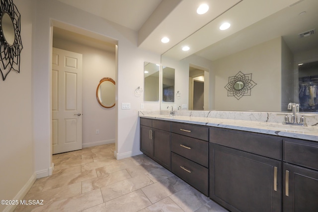 bathroom with recessed lighting, a sink, visible vents, baseboards, and double vanity