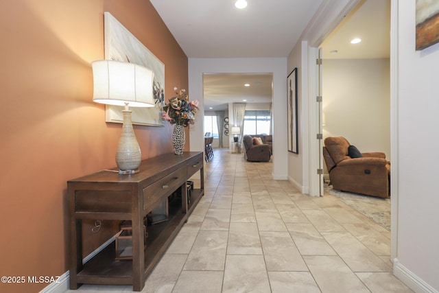 hallway featuring recessed lighting and baseboards