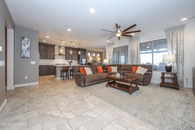 living room featuring recessed lighting, ceiling fan, and baseboards