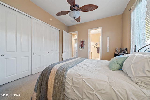 bedroom with ensuite bath, a closet, ceiling fan, and carpet flooring