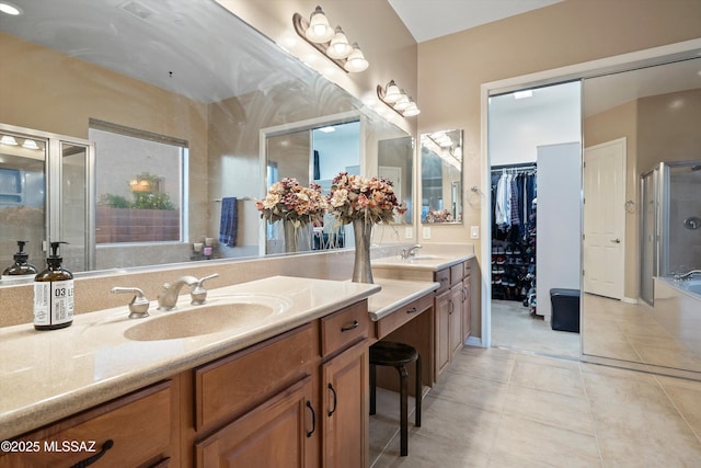 bathroom featuring tile patterned floors, vanity, and an enclosed shower