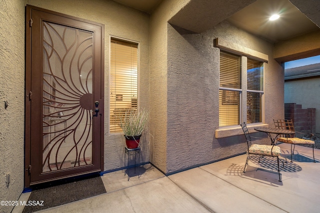 property entrance with a patio area