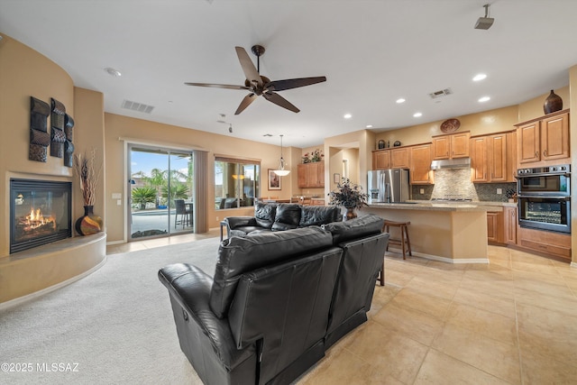 living room featuring light tile patterned floors and ceiling fan