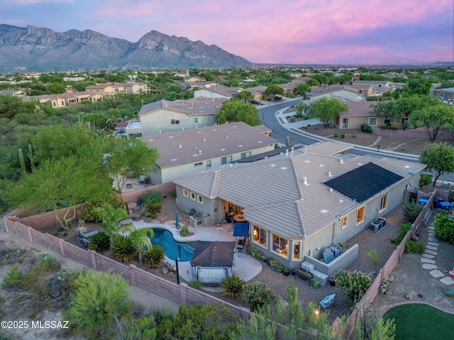 aerial view at dusk featuring a mountain view