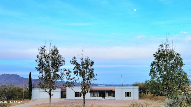 view of front of property featuring a mountain view and a garage