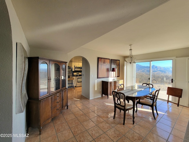 dining area with light tile patterned floors and a mountain view