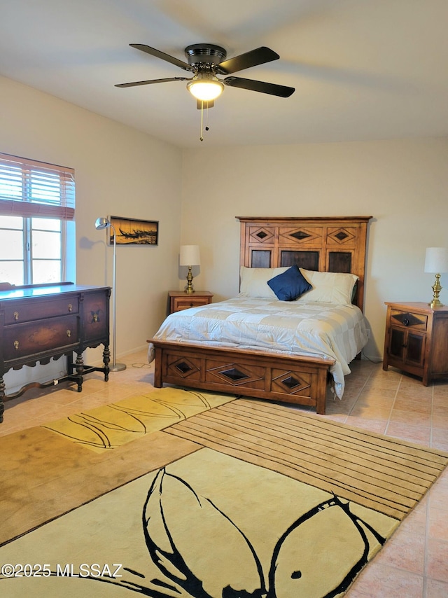 tiled bedroom featuring ceiling fan