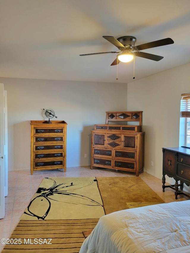 tiled bedroom featuring ceiling fan