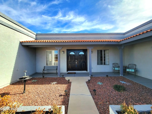 view of exterior entry with a porch