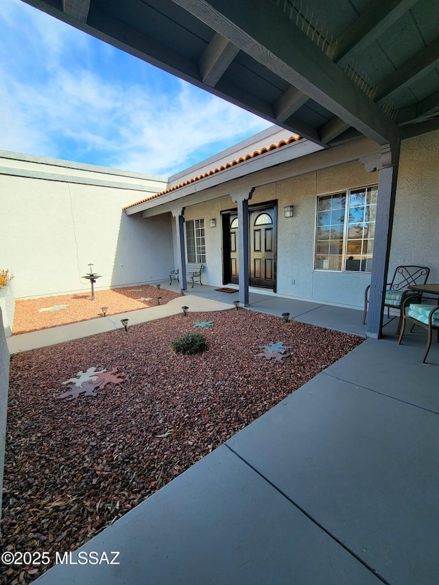 entrance to property with a patio area