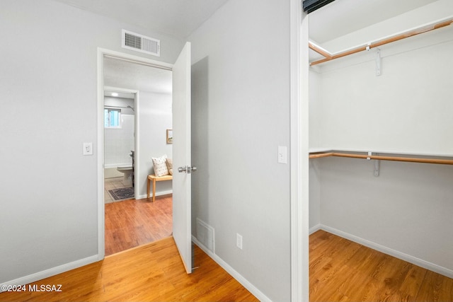 spacious closet with hardwood / wood-style floors