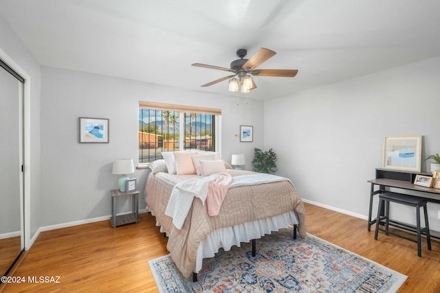 bedroom featuring light hardwood / wood-style flooring, a closet, and ceiling fan