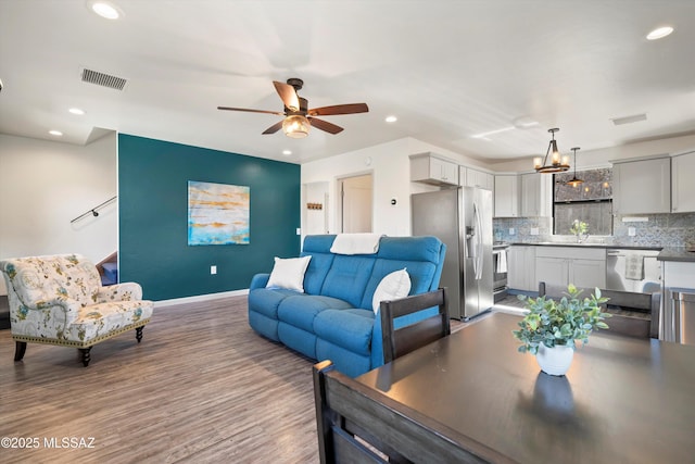 living room with recessed lighting and visible vents