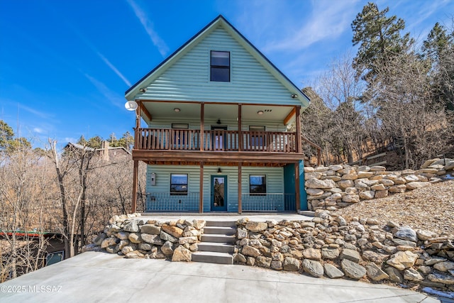 chalet / cabin featuring a porch and a balcony