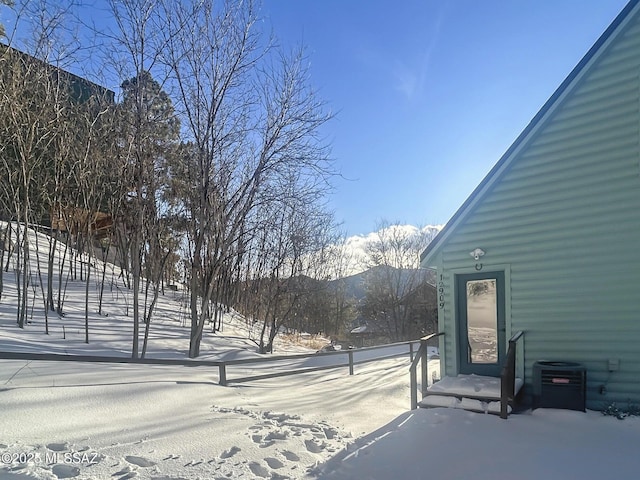 yard covered in snow with central AC unit