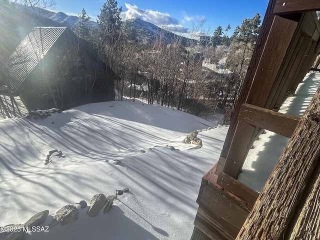 snowy yard with a mountain view