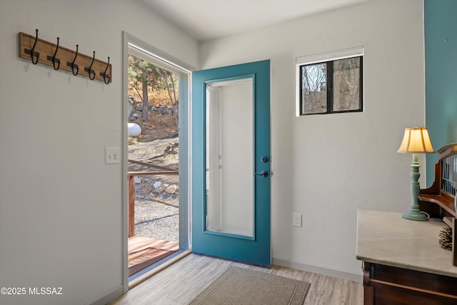 entryway featuring light wood-style floors and baseboards