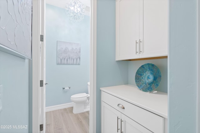 bathroom with toilet and hardwood / wood-style floors