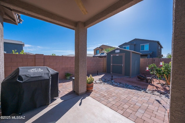 view of patio / terrace with a storage shed and grilling area