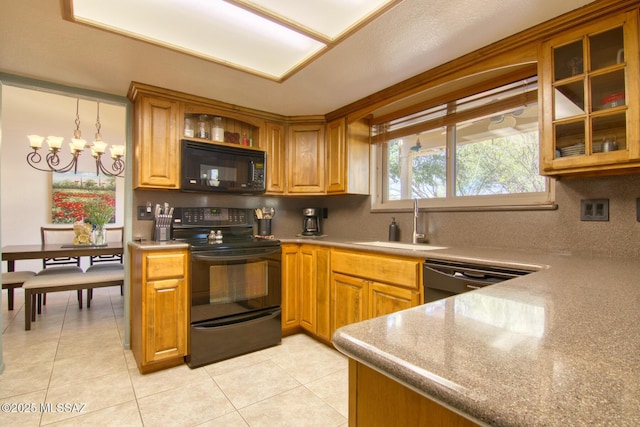 kitchen with light tile patterned floors, decorative backsplash, brown cabinets, black appliances, and a sink