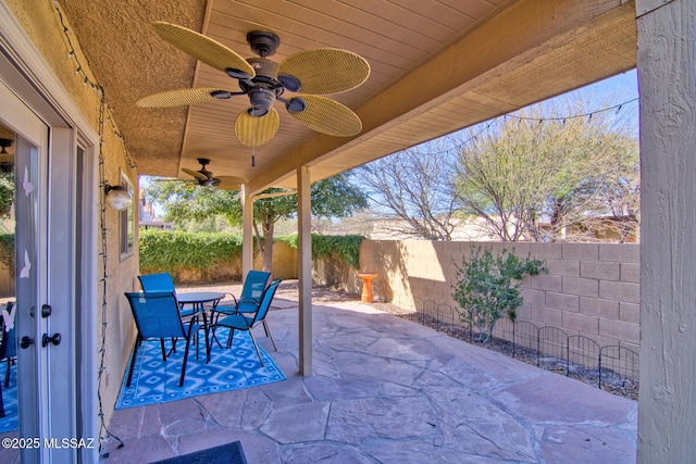 view of patio / terrace featuring outdoor dining space, a fenced backyard, and ceiling fan